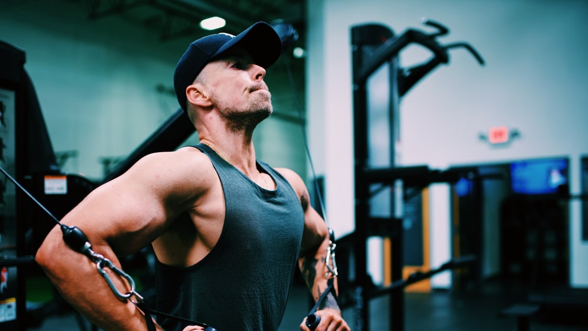 Gordon Cowie working out at the gym doing a cable fly.